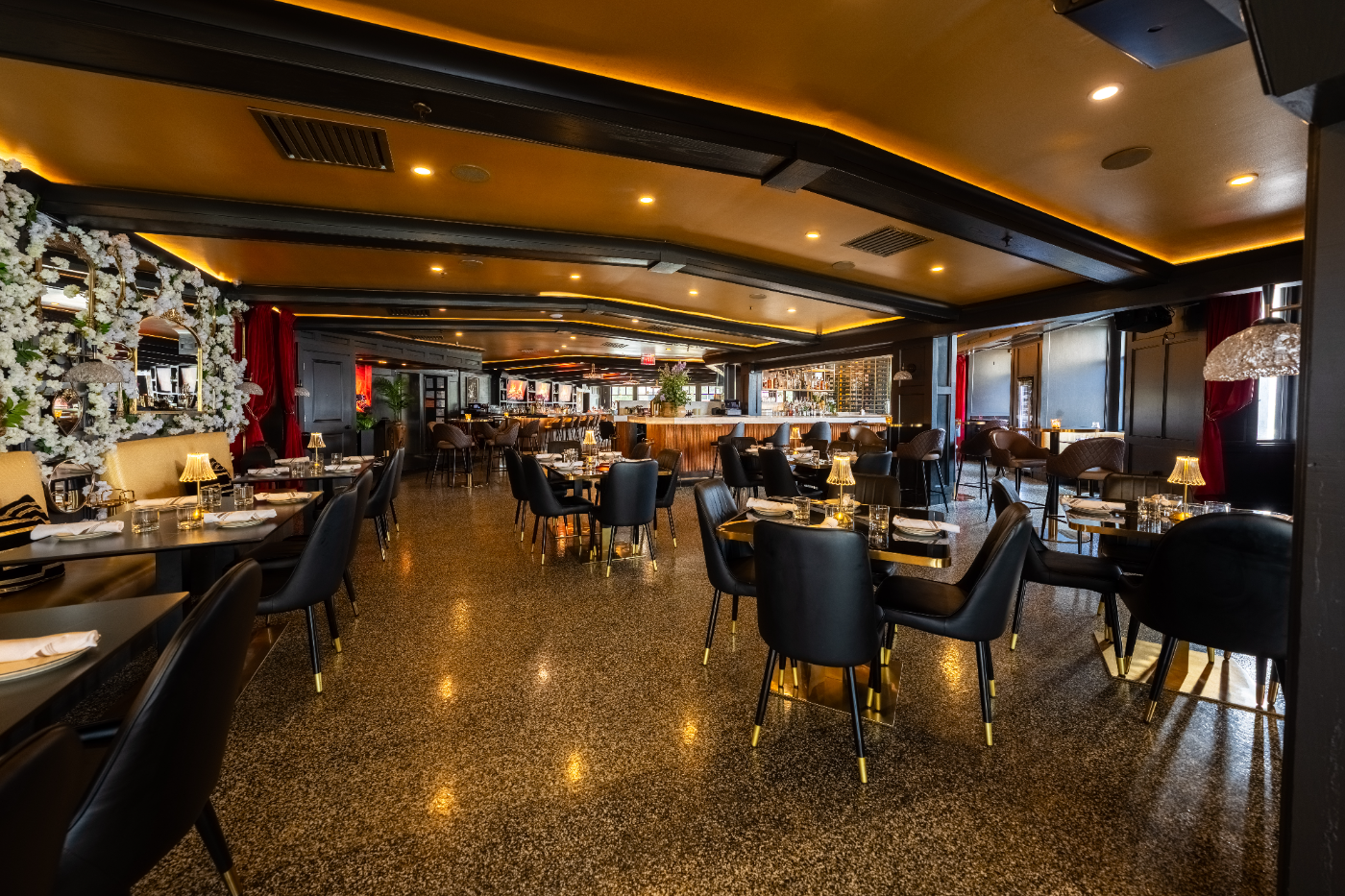 Fuego’s dining room with stone accents and warm golden ceilings