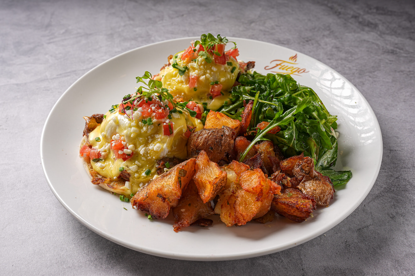 Eggs Benedict with hollandaise and breakfast potatoes