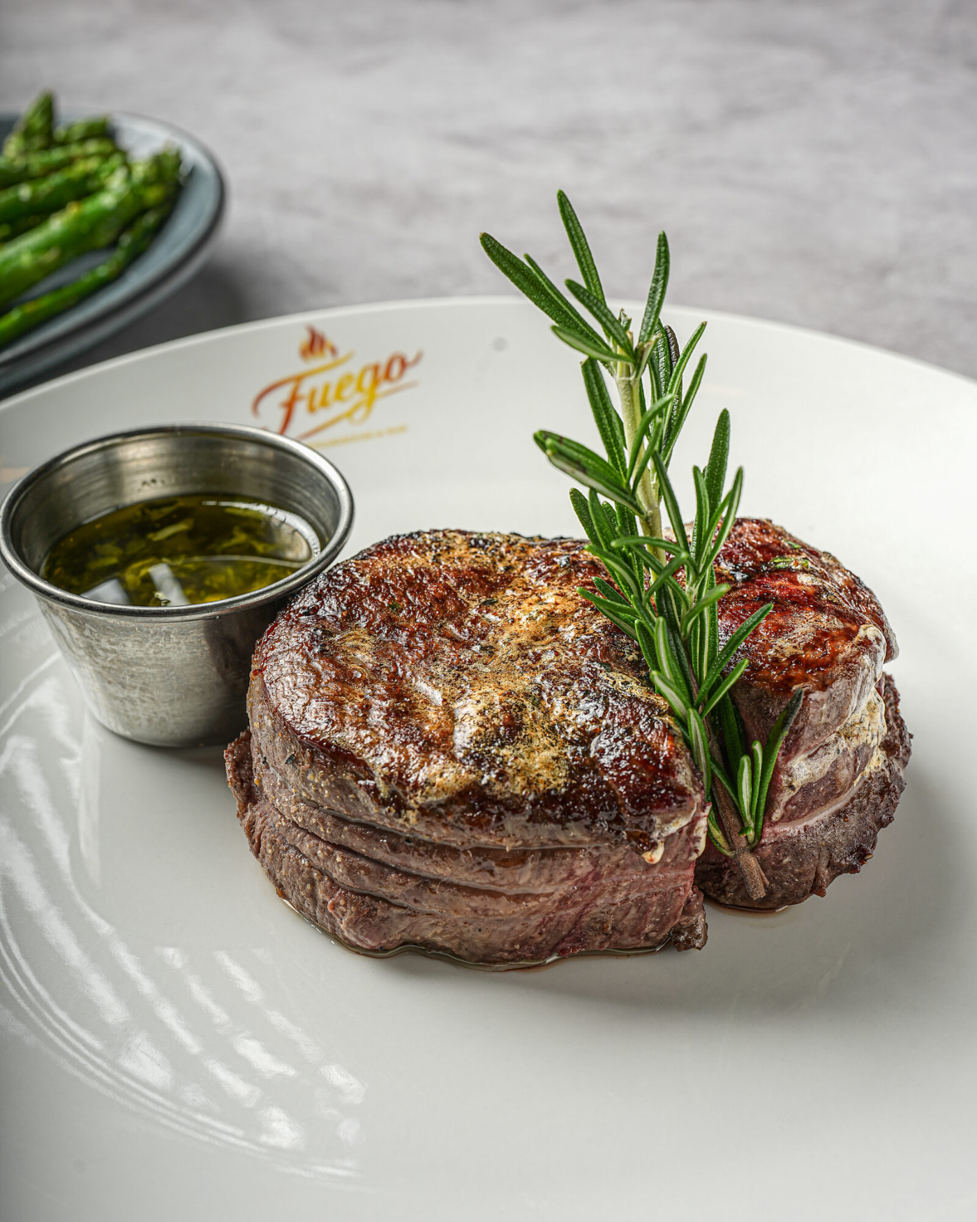 Bacon-wrapped filet mignon finished with rosemary
